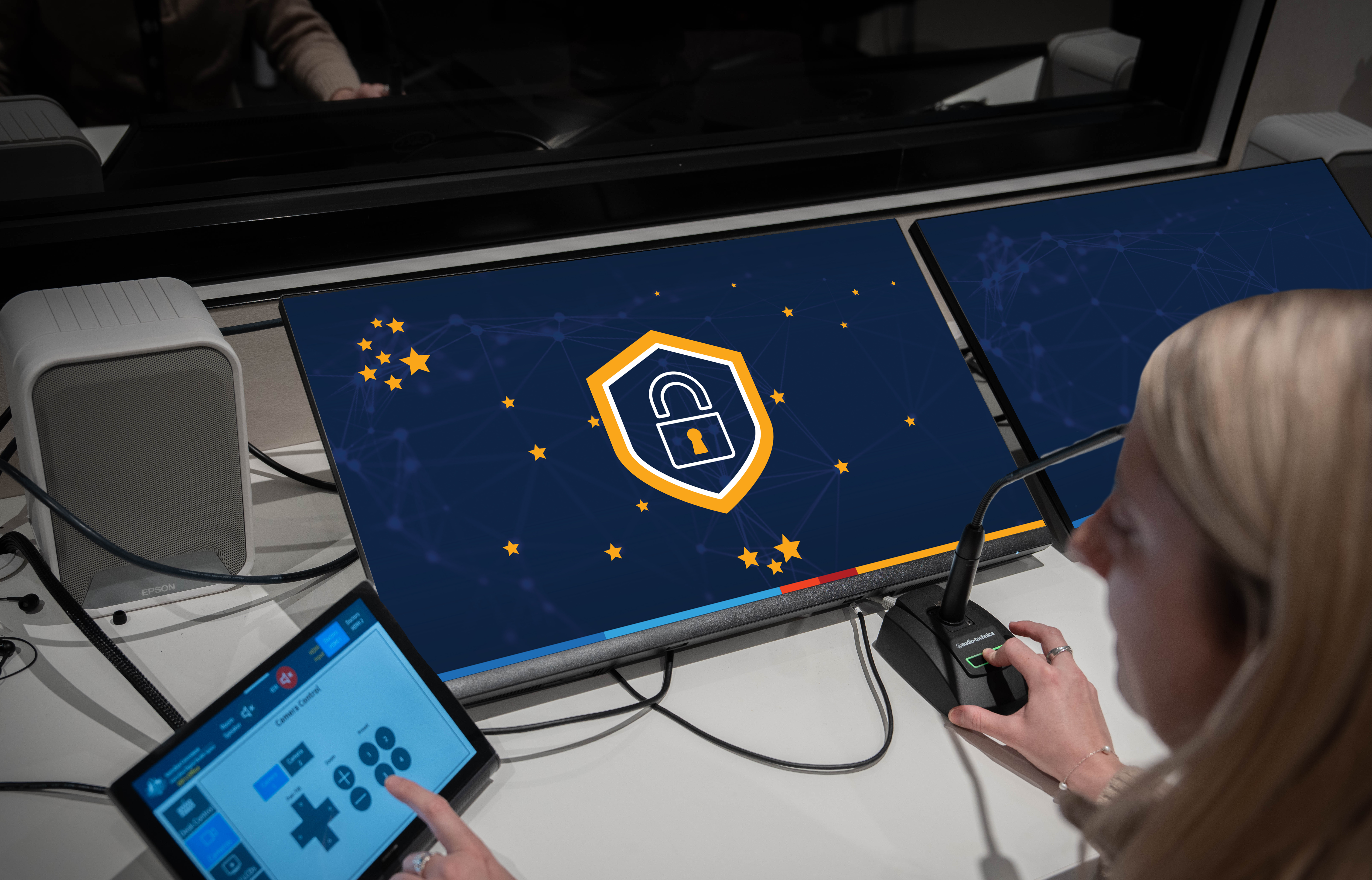 woman using a computer with security shield icon shown on screen